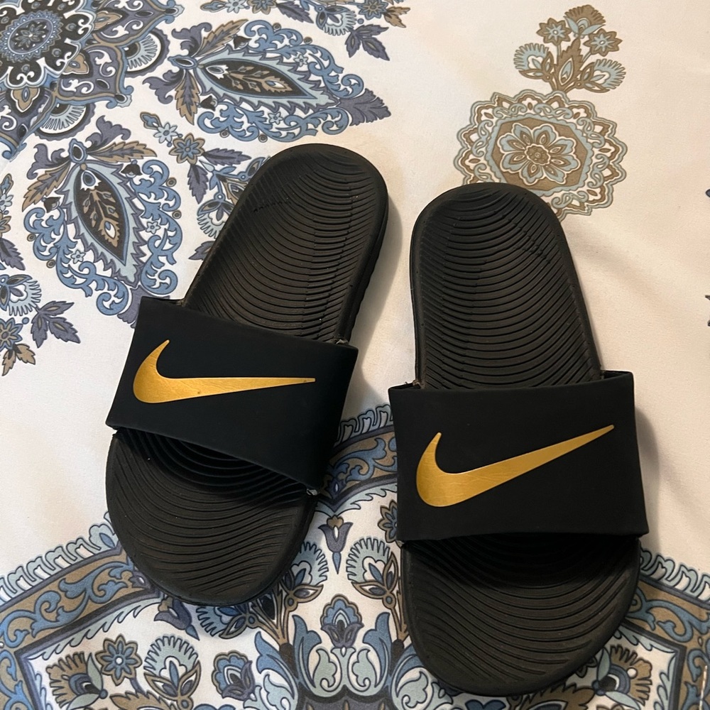 Nike Black Slides with Gold Swoosh